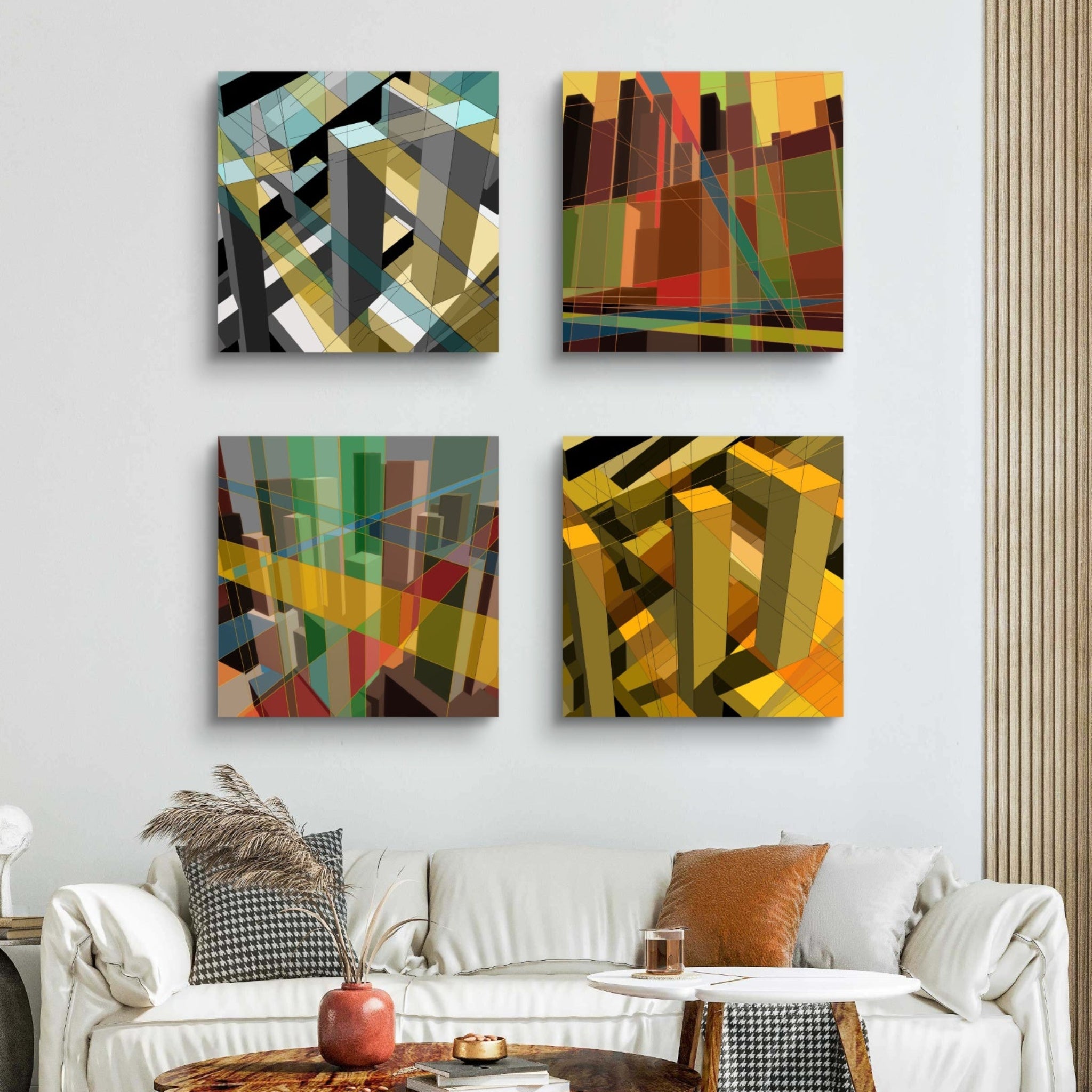 Square collage of four abstract urban art pieces on a wall above a white sofa in a living room.